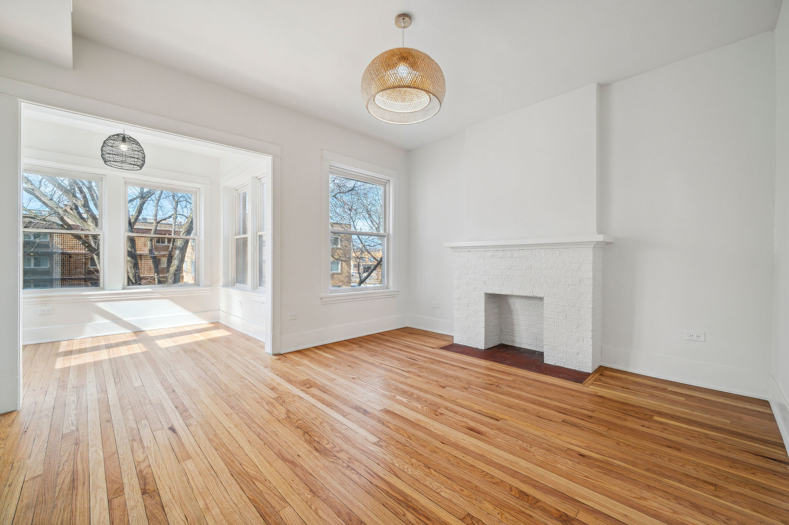 1928 Harrison Street, Unit 1 Evanston, IL 60201 - Photo 2 of 11 a view of empty room with wooden floor and fan