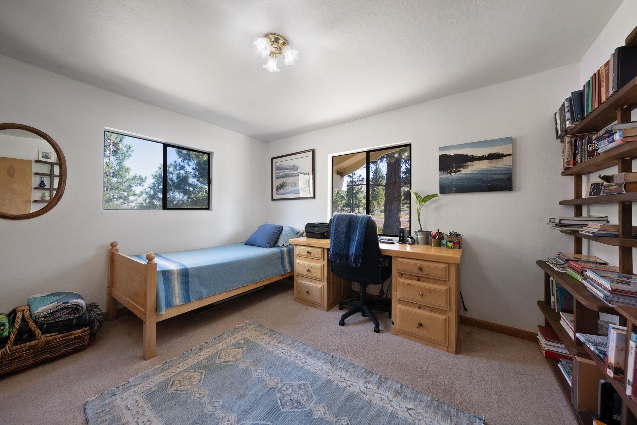 185 Smithneck Road Loyalton, CA 96118 - Photo 24 of 31 a bedroom with a bed and a chandelier