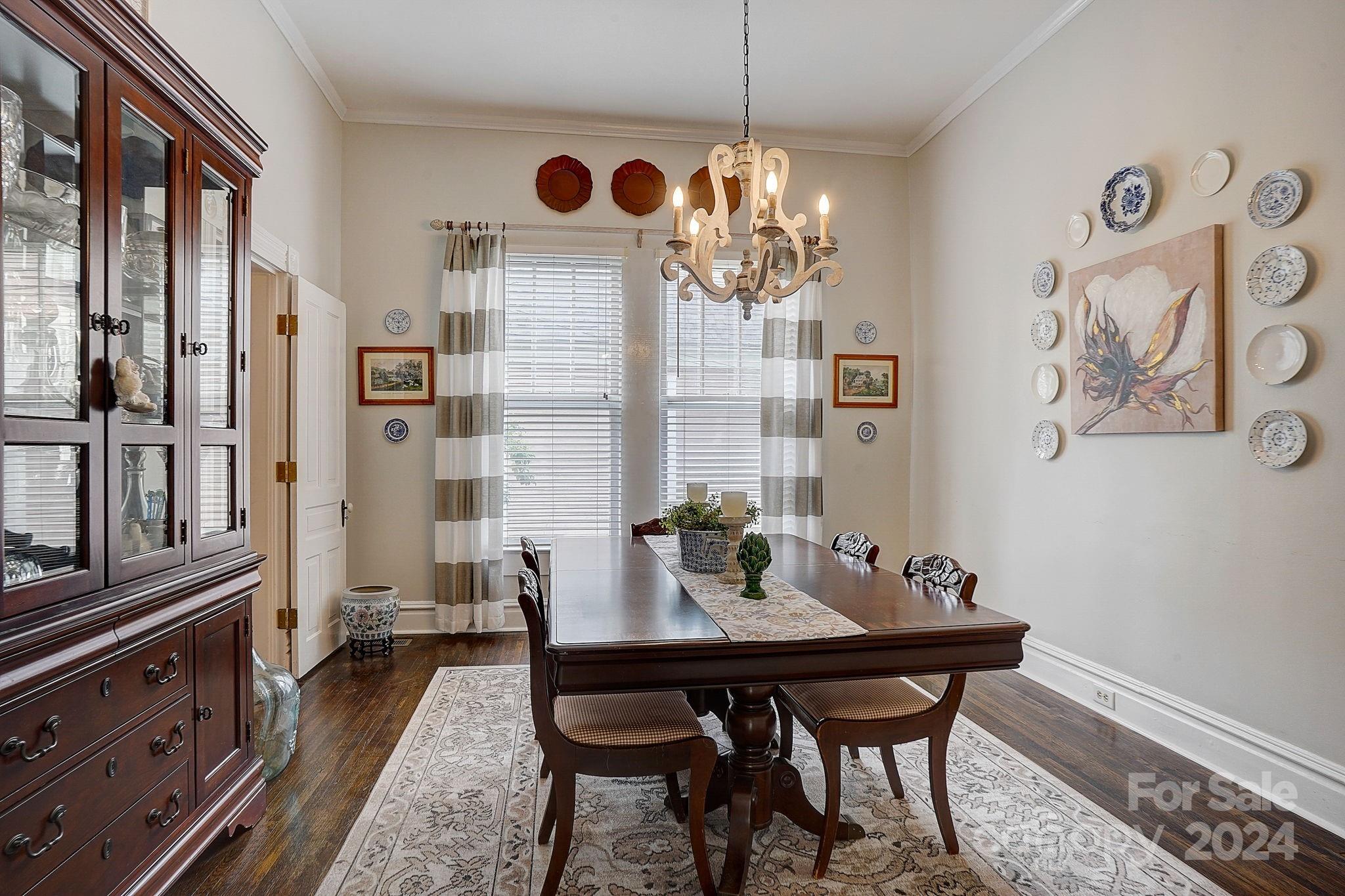 179 Union Street South Concord, NC 28025 - Photo 11 of 38 a view of a dining room with furniture a chandelier and wooden floor