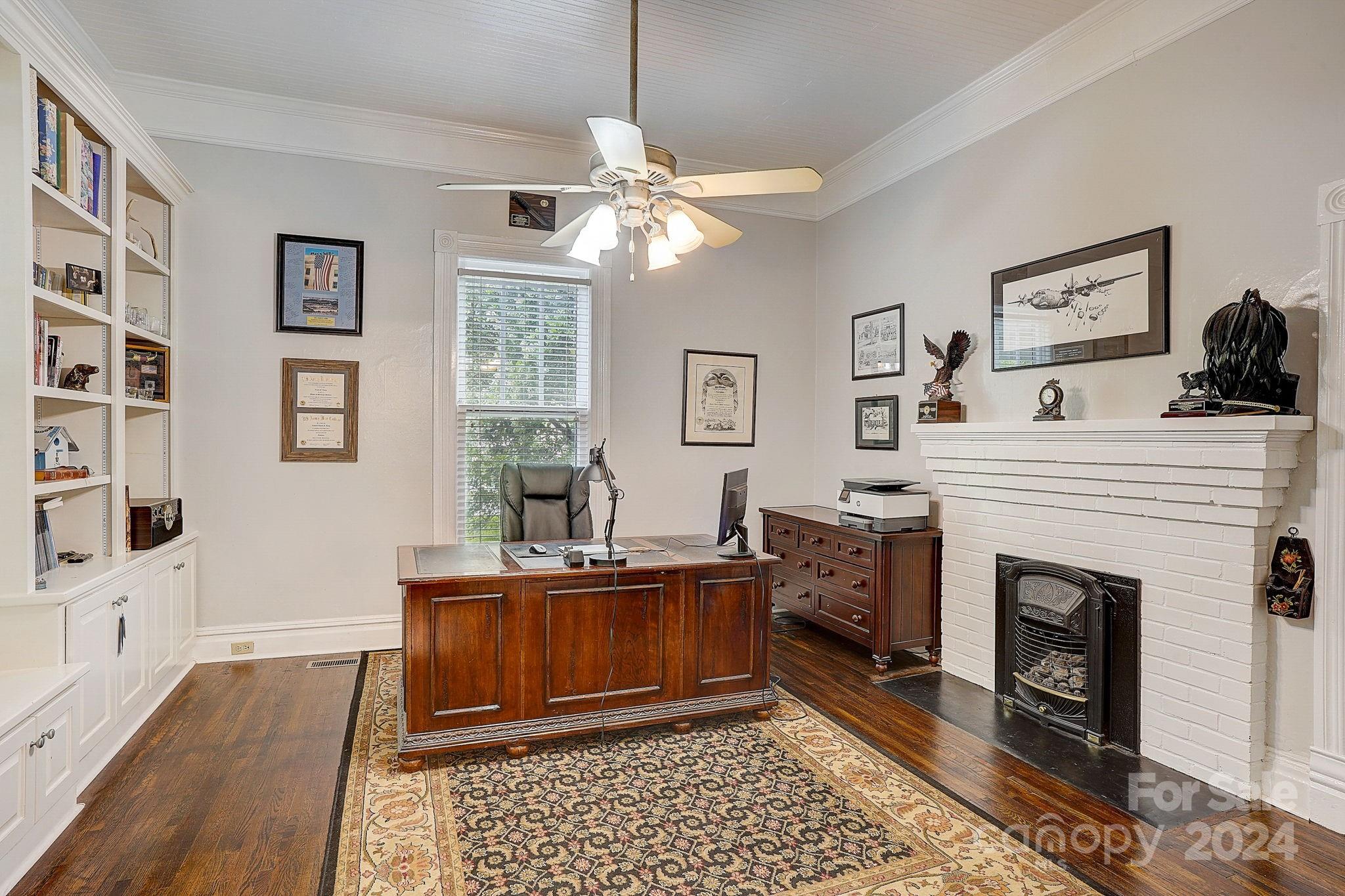 179 Union Street South Concord, NC 28025 - Photo 16 of 38 a room with fireplace a chandelier and a rug