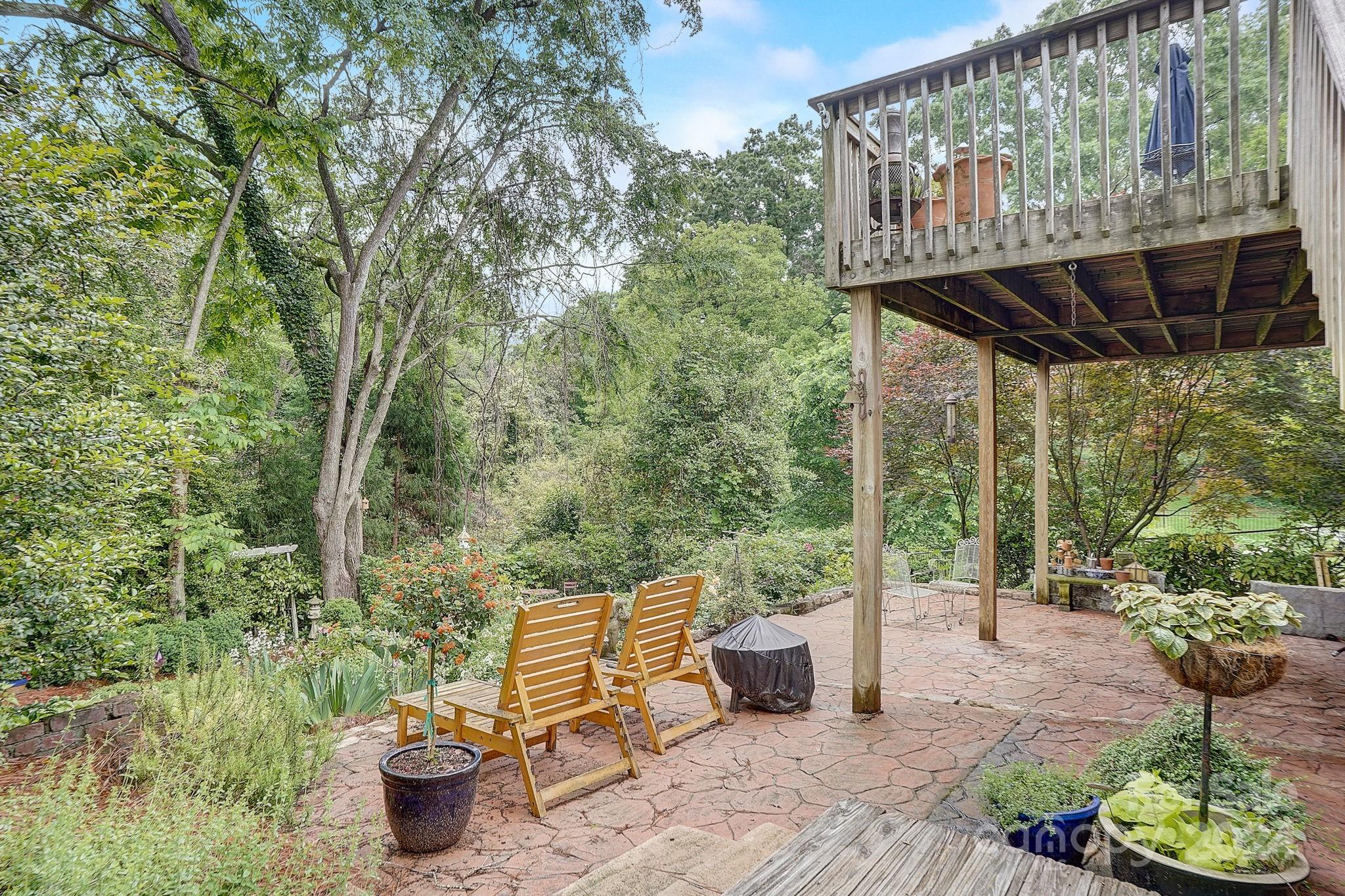 179 Union Street South Concord, NC 28025 - Photo 36 of 38 a view of a patio with table and chairs potted plants with wooden floor and fence