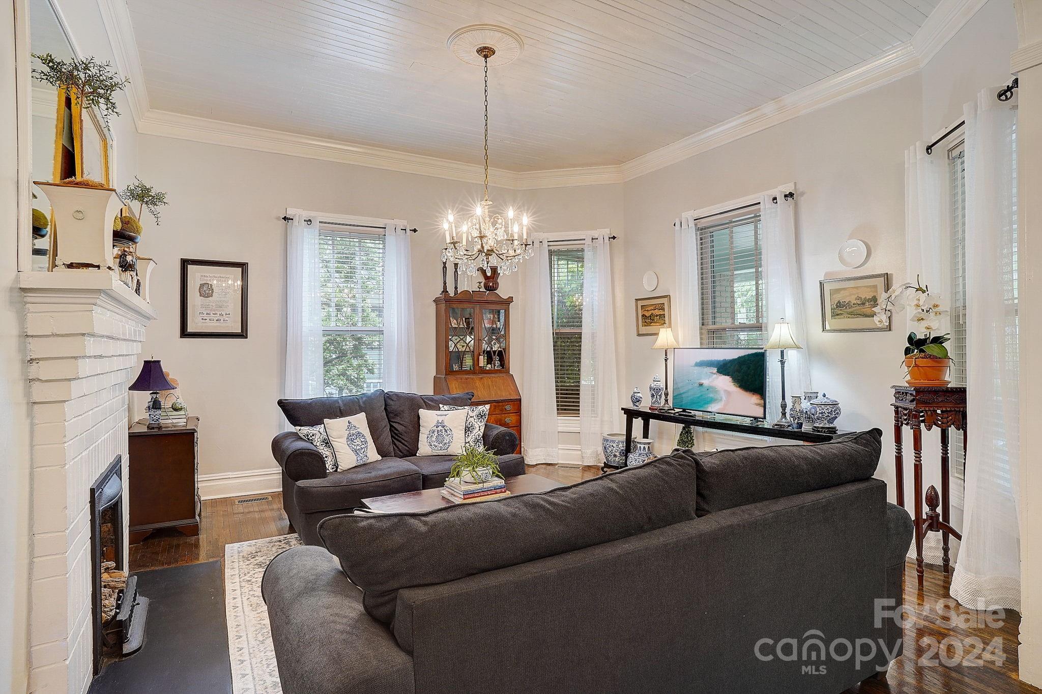 179 Union Street South Concord, NC 28025 - Photo 7 of 38 a living room with furniture and a chandelier