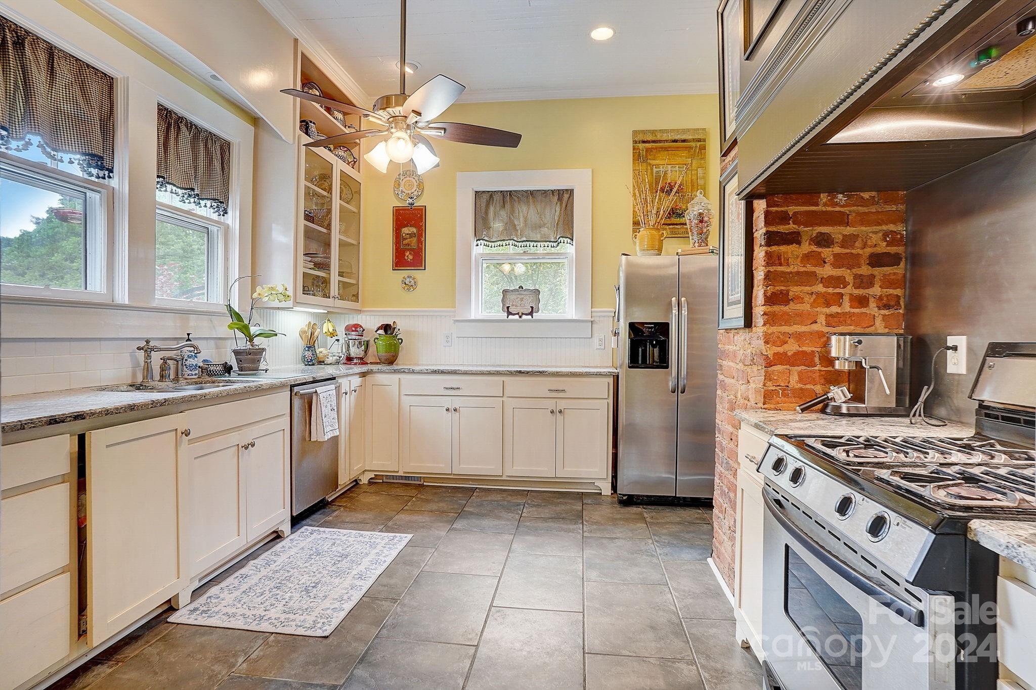 179 Union Street South Concord, NC 28025 - Photo 8 of 38 a kitchen with a stove top oven sink and cabinets