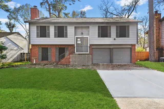 a front view of a house with a garden and yard