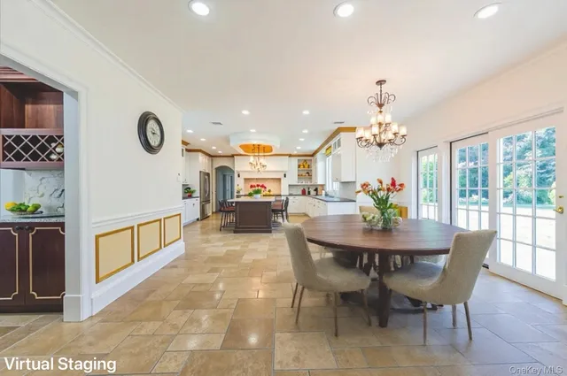 a view of a dining room with furniture and a chandelier