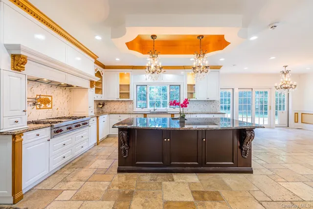 a kitchen with stainless steel appliances kitchen island granite countertop a stove and cabinets