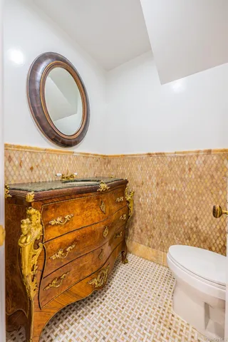 a bathroom with a granite countertop sink toilet a mirror and shower