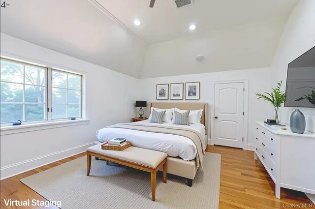a spacious bedroom with a bed and a window