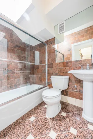 a bathroom with a sink a toilet and bathtub