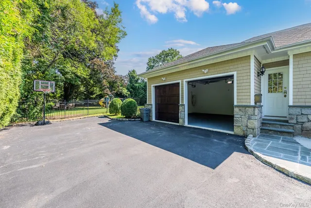 a view of a house with a yard and garage