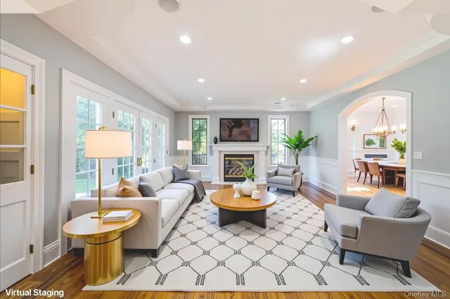 a living room with fireplace furniture and a large window
