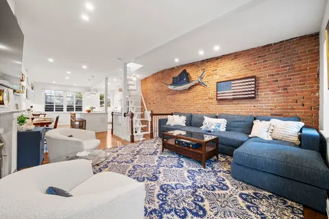 a living room with furniture and kitchen view
