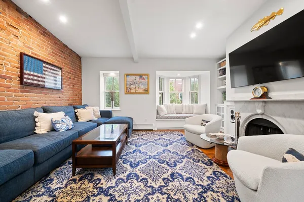 a living room with furniture flat screen tv and a fireplace