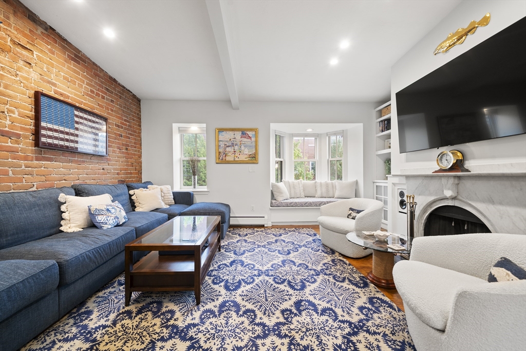 57 Warren Avenue, Unit 3 Boston, MA 02116 - Photo 13 of 24 a living room with furniture flat screen tv and a fireplace