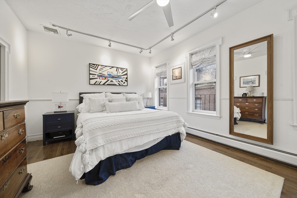 57 Warren Avenue, Unit 3 Boston, MA 02116 - Photo 14 of 24 a spacious bedroom with a bed and window