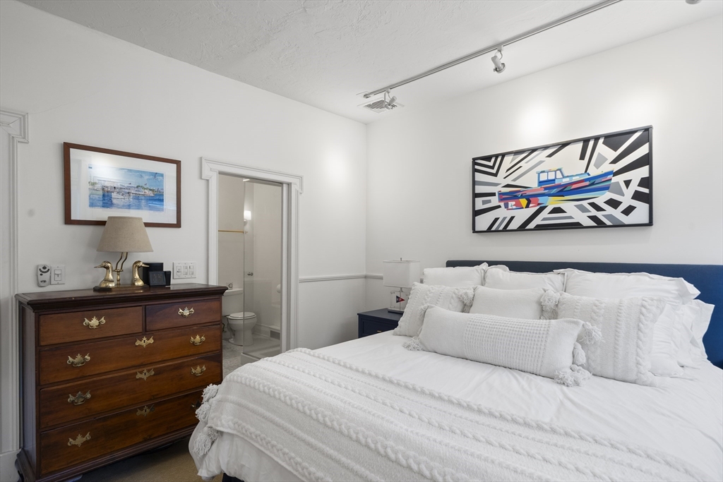 57 Warren Avenue, Unit 3 Boston, MA 02116 - Photo 15 of 24 a bedroom with a bed and painting on the wall