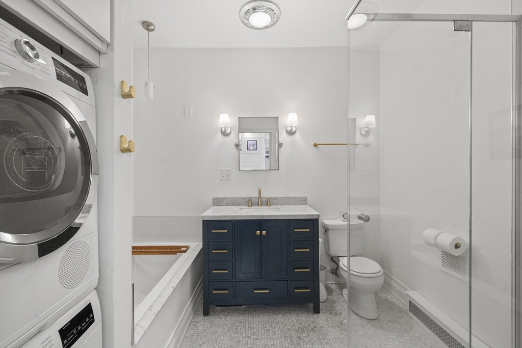 57 Warren Avenue, Unit 3 Boston, MA 02116 - Photo 16 of 24 a spacious bathroom with a sink a toilet and a mirror