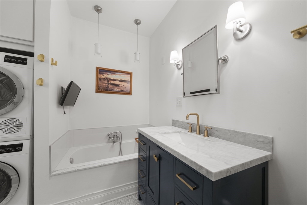 57 Warren Avenue, Unit 3 Boston, MA 02116 - Photo 17 of 24 a bathroom with a sink a bathtub and a mirror