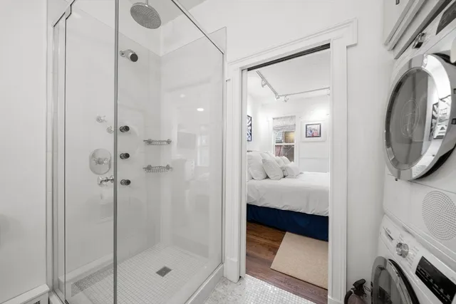 a bathroom with a shower and mirror