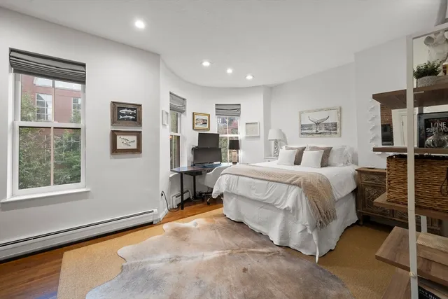 a spacious bedroom with a bed and a window