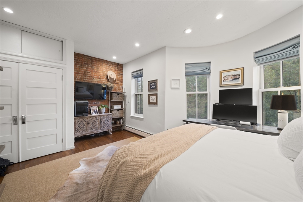 57 Warren Avenue, Unit 3 Boston, MA 02116 - Photo 20 of 24 a bedroom with a bed a flat screen tv and dresser