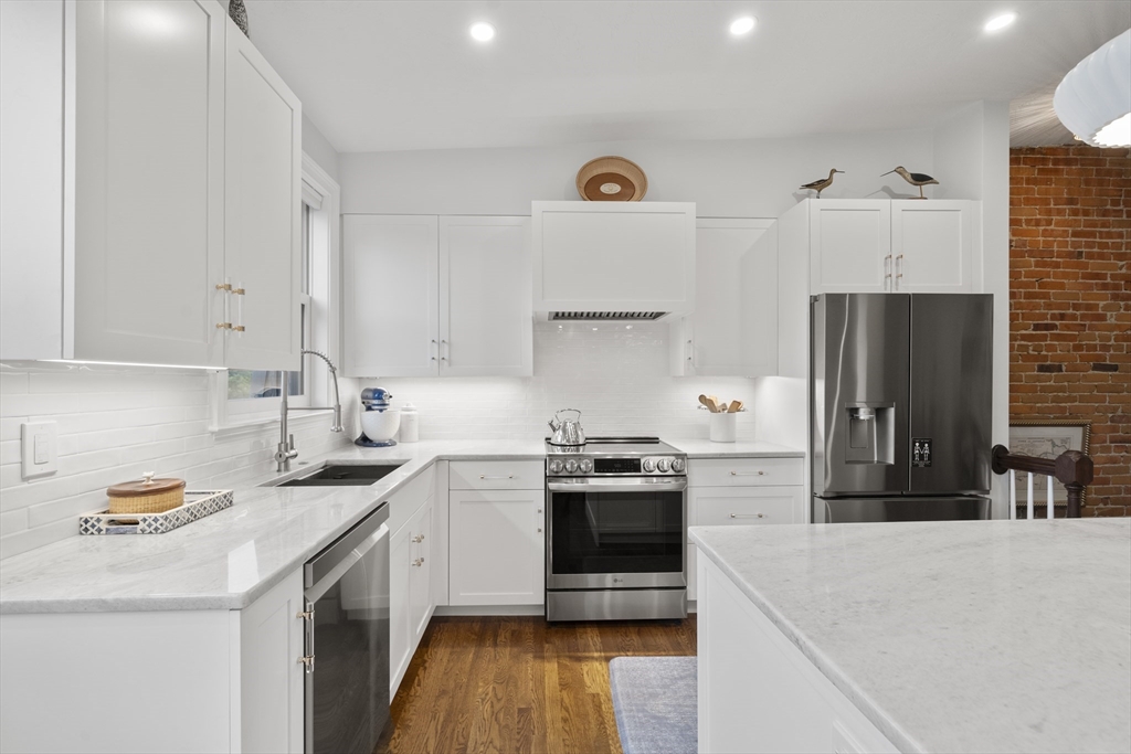 57 Warren Avenue, Unit 3 Boston, MA 02116 - Photo 2 of 24 a kitchen with stainless steel appliances granite countertop a sink stove and refrigerator
