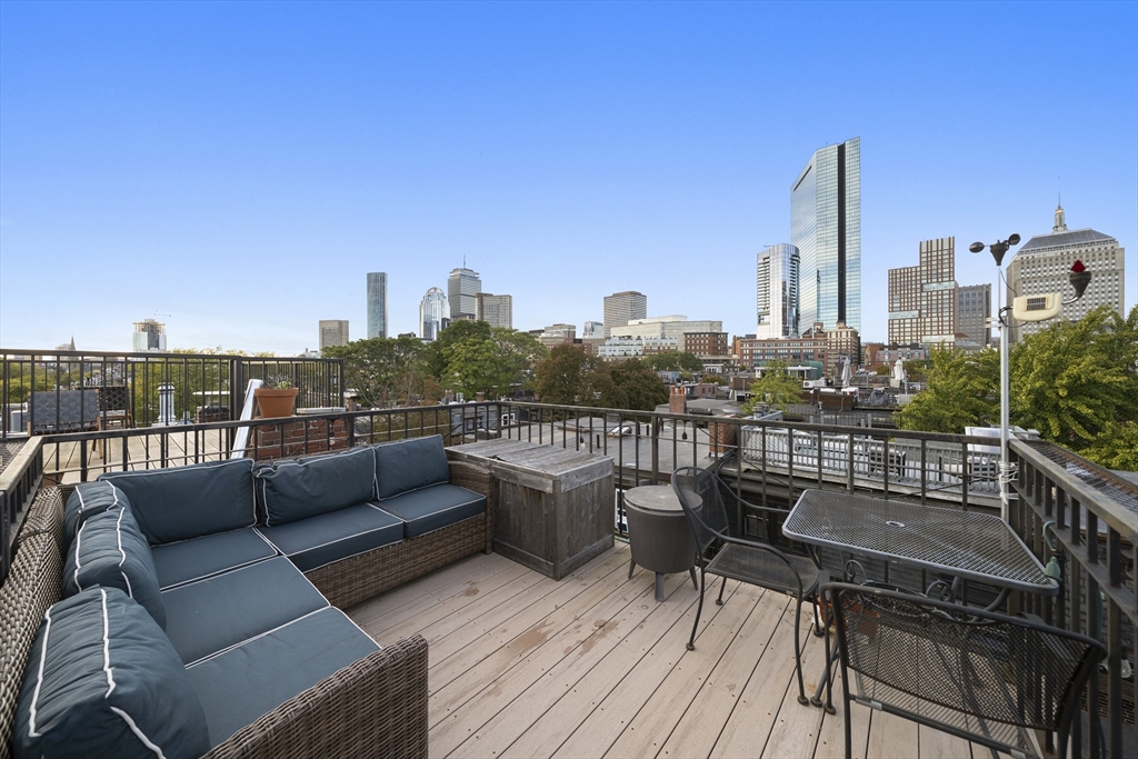 57 Warren Avenue, Unit 3 Boston, MA 02116 - Photo 22 of 24 a view of a roof deck with couches and wooden floor