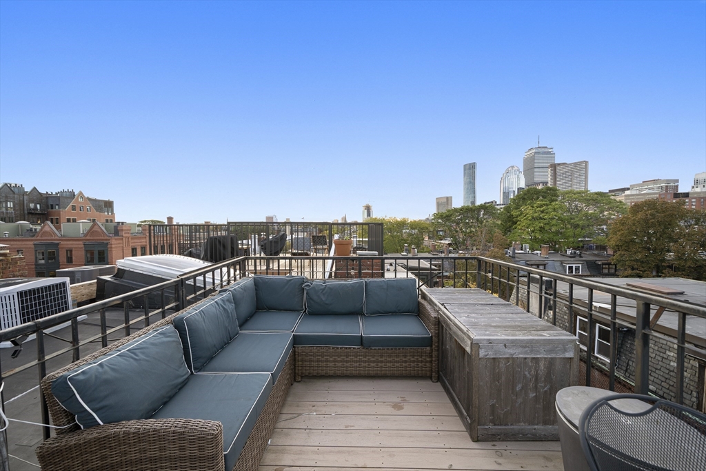 57 Warren Avenue, Unit 3 Boston, MA 02116 - Photo 23 of 24 a view of a roof deck with couches and sky view
