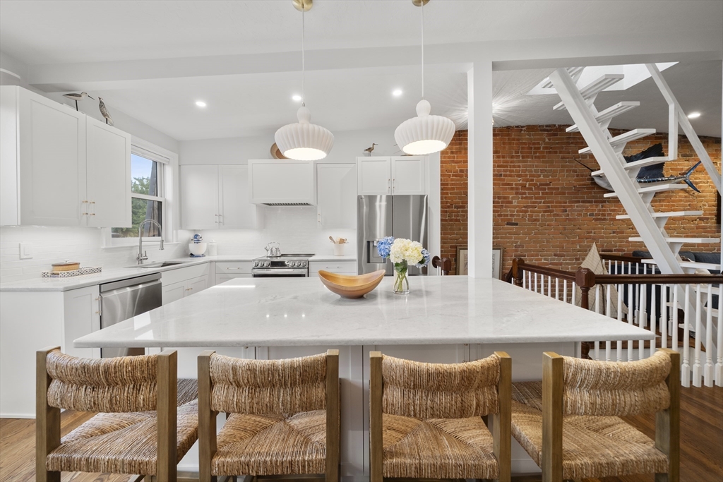 57 Warren Avenue, Unit 3 Boston, MA 02116 - Photo 4 of 24 a kitchen with stainless steel appliances kitchen island granite countertop a sink and a white cabinets