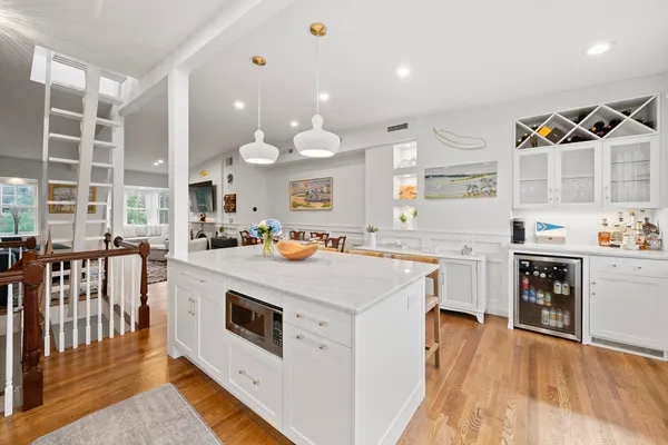a kitchen with kitchen island granite countertop a stove and a sink
