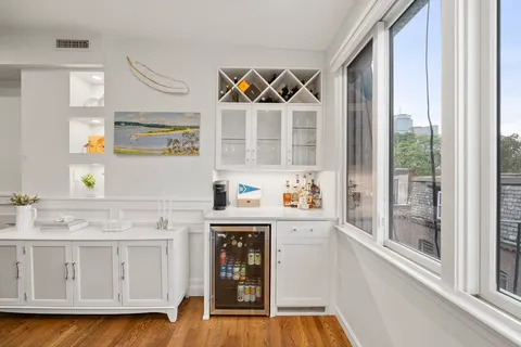 a kitchen with granite countertop a sink and a stove next to a window