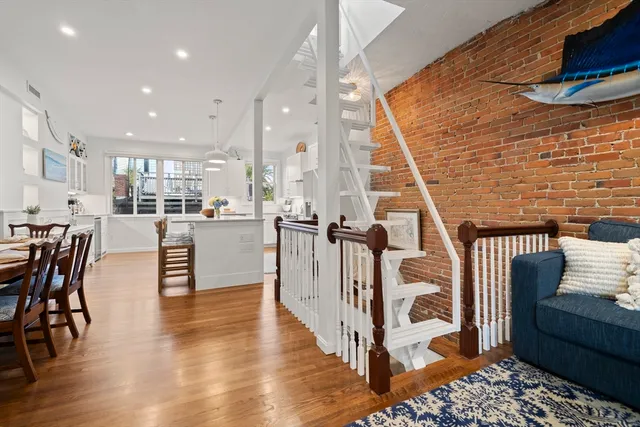 a dining room with furniture and wooden floor