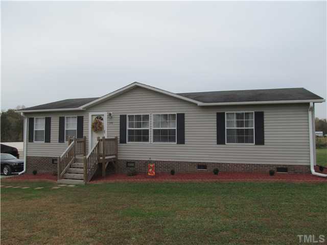 a front view of house with yard and outdoor seating