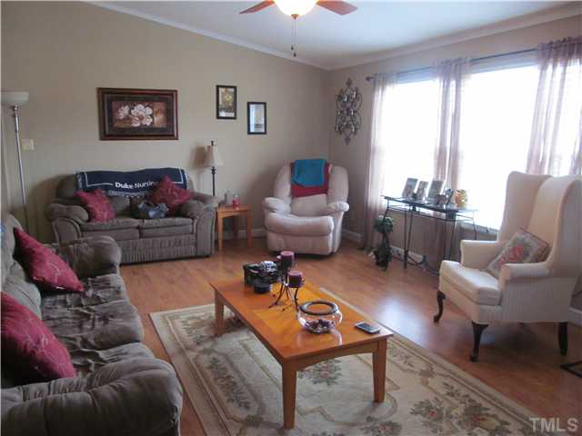 130 Dustin Lane Roxboro, NC 27574 - Photo 5 of 15 a living room with furniture a rug and a large window