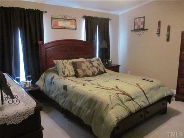 130 Dustin Lane Roxboro, NC 27574 - Photo 10 of 15 a bedroom with a bed and dresser