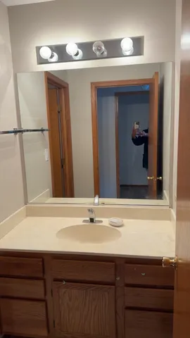 an empty room with windows and ceiling fan