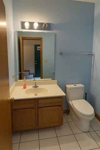a bathroom with a sink toilet and mirror