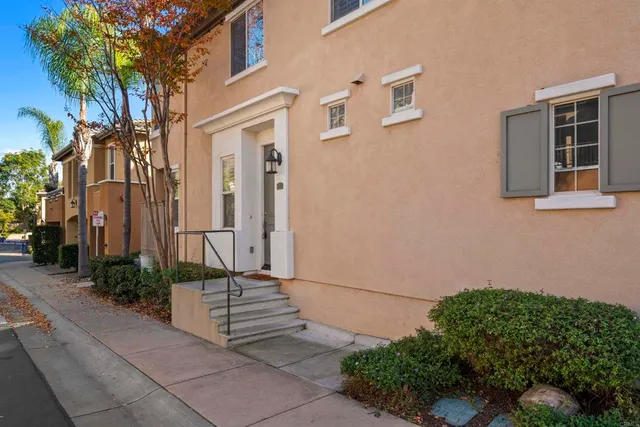 a view of a house with wooden fence and windows