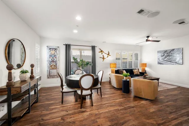 a living room with furniture a clock and a window
