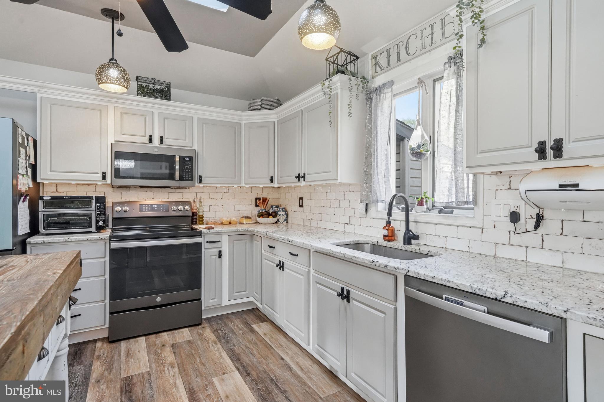 705 Garden Road Pittsgrove, NJ 08318 - Photo 26 of 72 a kitchen with granite countertop a sink stainless steel appliances and cabinets