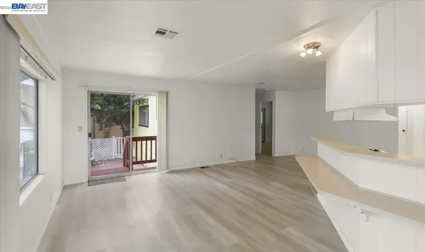a view of a room with an empty room and wooden floor