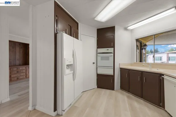 a kitchen with stainless steel appliances granite countertop a refrigerator and a sink