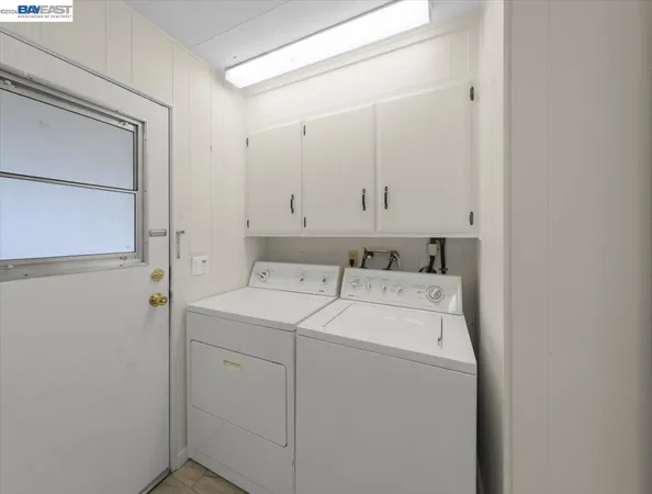 a view of an empty room with closet and a window