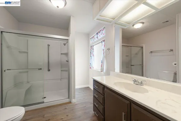 a view of an empty room with window and closet area