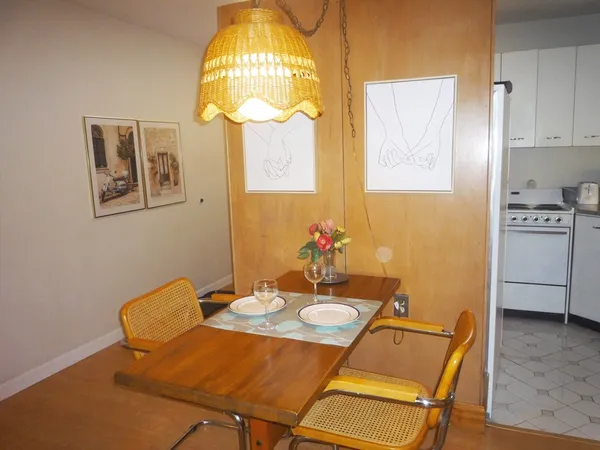 a view of a dining room with furniture and chandelier
