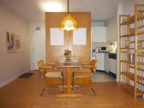 a dining room with furniture and chandelier