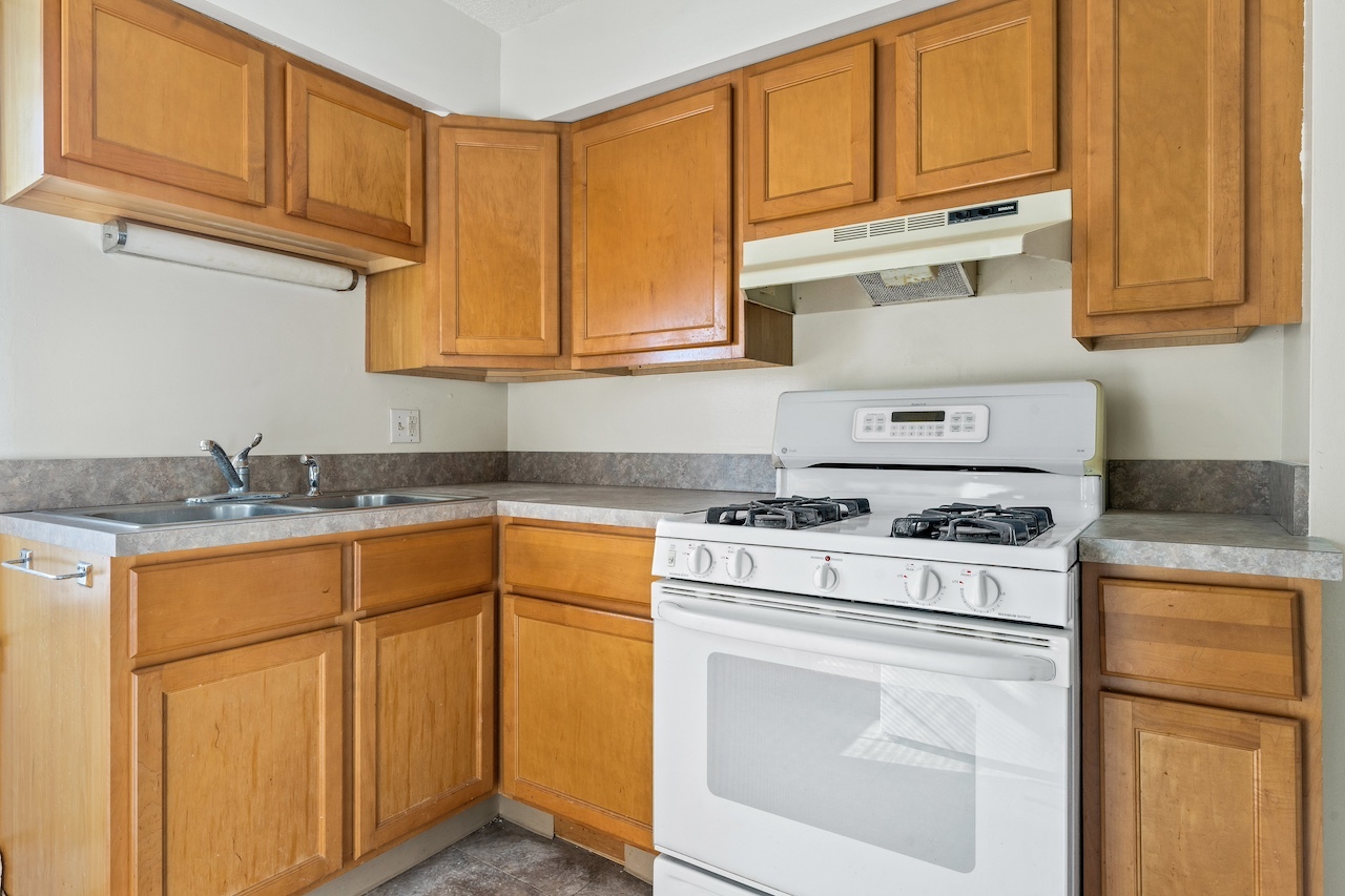 3701 216th Street Matteson, IL 60443 - Photo 6 of 26 a kitchen with granite countertop cabinets stainless steel appliances and a sink