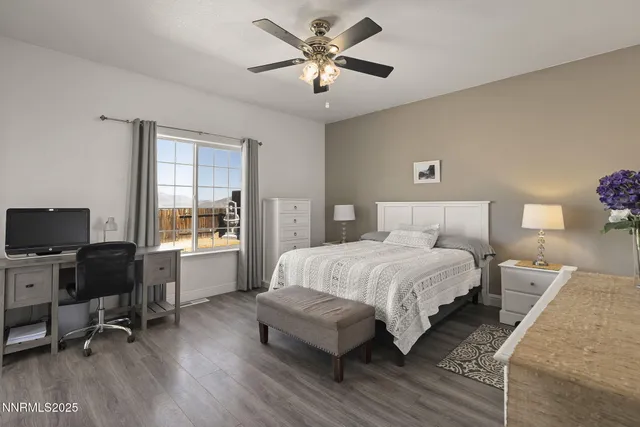 a bedroom with a bed and a desk