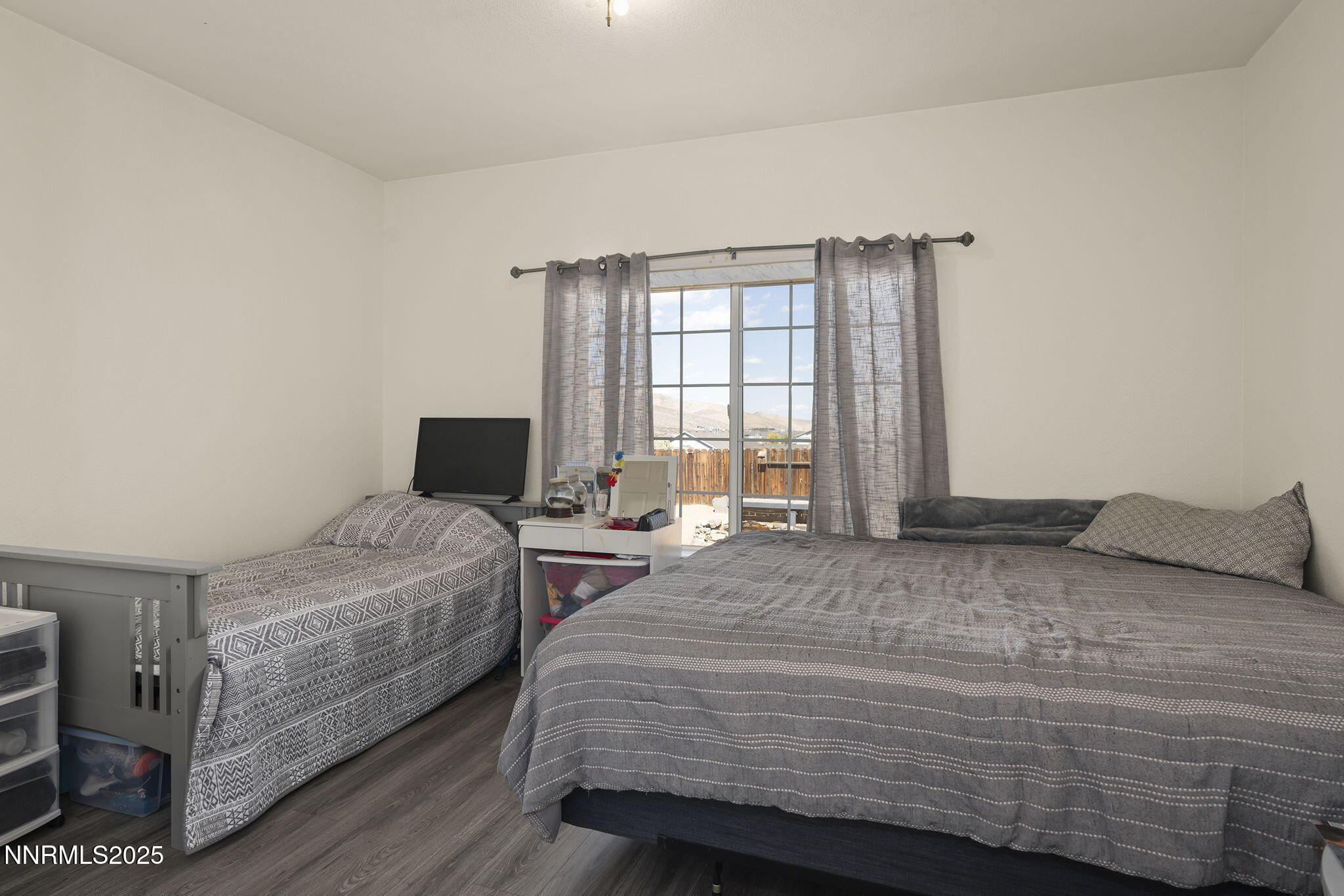 1030 Haystack Drive Carson City, NV 89705 - Photo 16 of 24 a bedroom with a bed and wooden floor