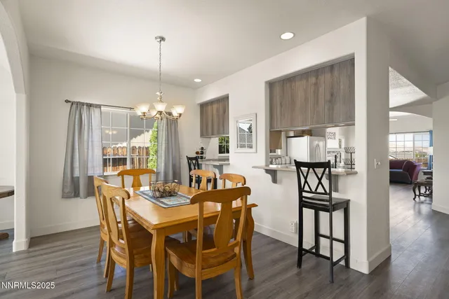 a dining room with furniture window and wooden floor